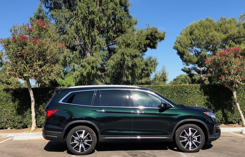 Green Honda Pilot In Front Of Trees
