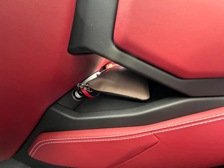 11 Things You'll Have to Get Used to When You Drive a Lamborghini Urus Supercar 11 This Tiny Nook Under The Center Screen Is The Perfect Place To Stow My Crossbody Bag
