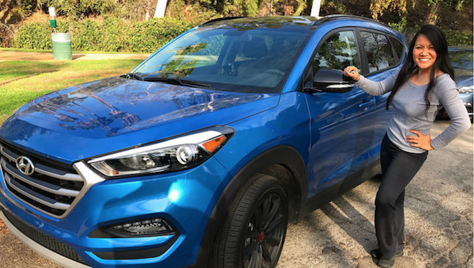 Which 2 Row SUVs Are Best For Child Car Seats? The Ultimate Car Seat Challenge 15 Woman Standing Next To A Blue 2017 Hyundai Tucson Compact Crossover